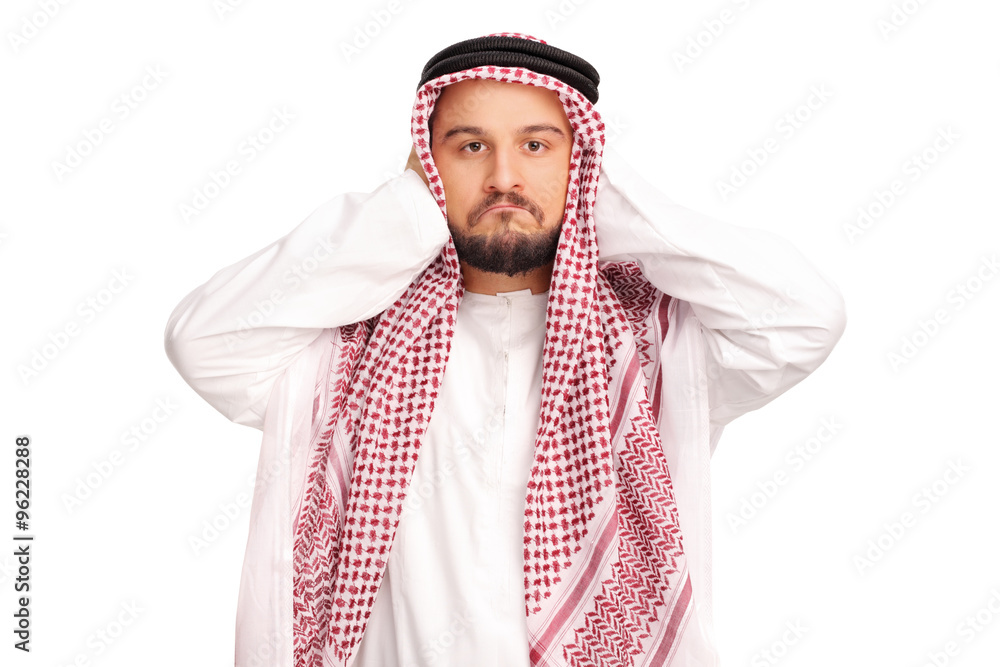 Reluctant male Arab covering his ears Reluctant male Arab covering his ears