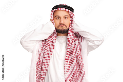 Obraz na płótnie Reluctant male Arab covering his ears