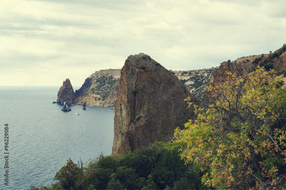  Autumn view of rocky cape Fiolent of Black sea, peak of Krestovaia (Cross) rock on foreground, Crimea, Russia, toned
