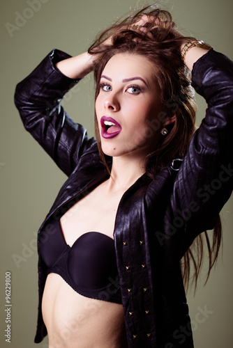 Picture of hot sexy pretty young lady wearing leather jacket and looking ar camera photo