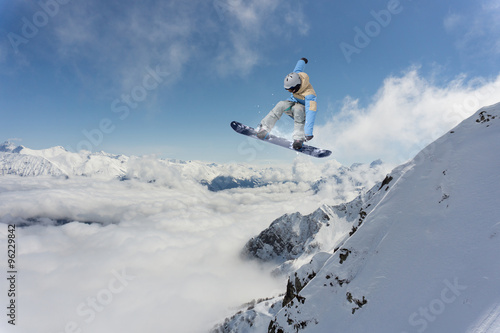 Flying snowboarder on mountains