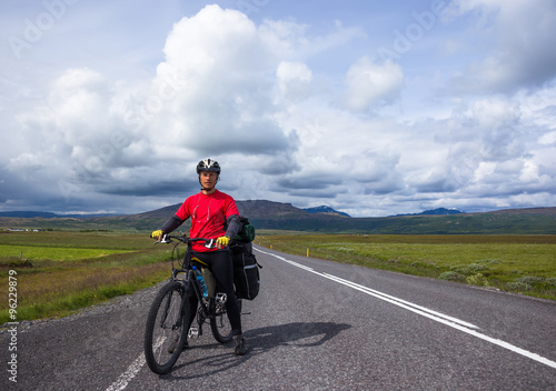 Fototapeta Naklejka Na Ścianę i Meble -  Biker rides on road at sunny summer day in Iceland