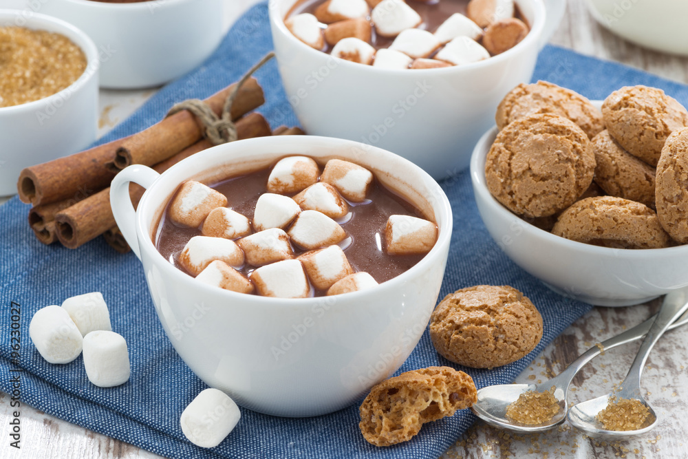 cup of cocoa with marshmallows and almond cookies on table cup of cocoa with marshmallows and almond cookies on table