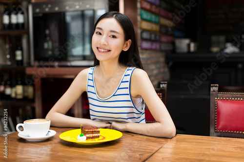 woman drinking coffee and having breakfast. © xin wang