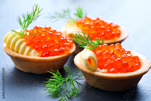 Tartlets with red caviar closeup. Gourmet food
