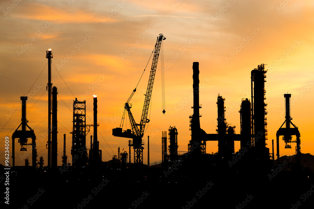 Silhouette of Oil refinery factory during construction at sunset