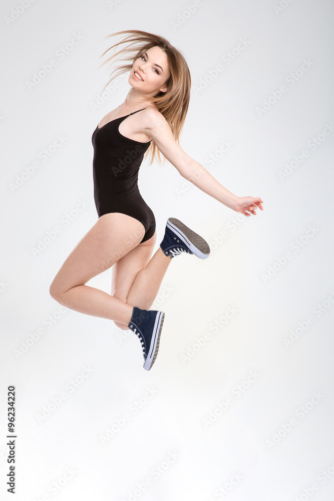 Young carefree joyful girl enjoying jumping