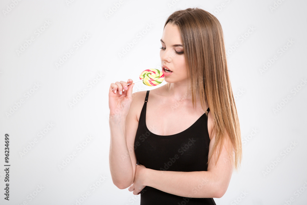 Sensual attractive girl tasting colorful candy Sensual attractive girl tasting colorful candy