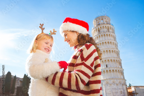 Happy mother in Christmas hat and daughter. Christmas in Pisa
