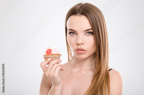 Closeup of young beautiful woman with cupcake