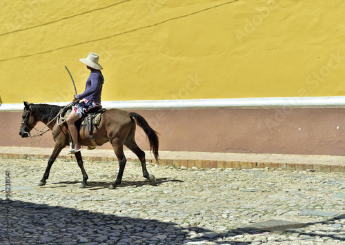 Cuban local man on horse on street in Trinidad, Cuba.