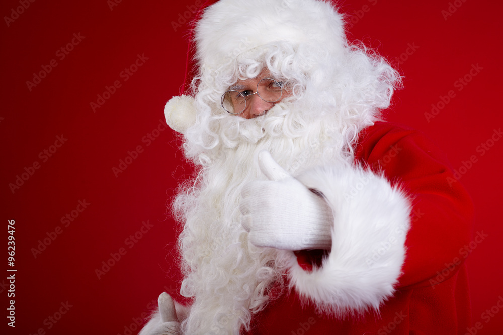 Santa Claus pointing in white blank sign with smile,christmas Santa Claus pointing in white blank sign with smile,christmas