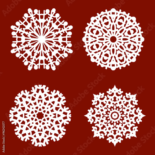 4 white isolated different snowflakes on a red background.