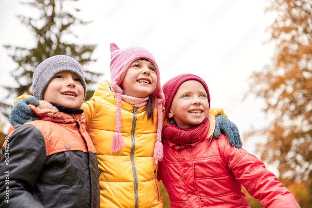 group of happy children hugging in autumn park group of happy children hugging in autumn park
