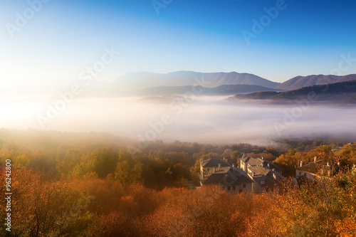 autumn scenery up early with fog in Zagorochoria, Epirus Greece photo