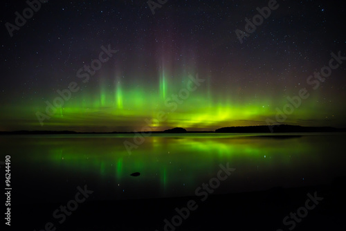 Northern lights over calm lake in Sweden (Aurora borealis)