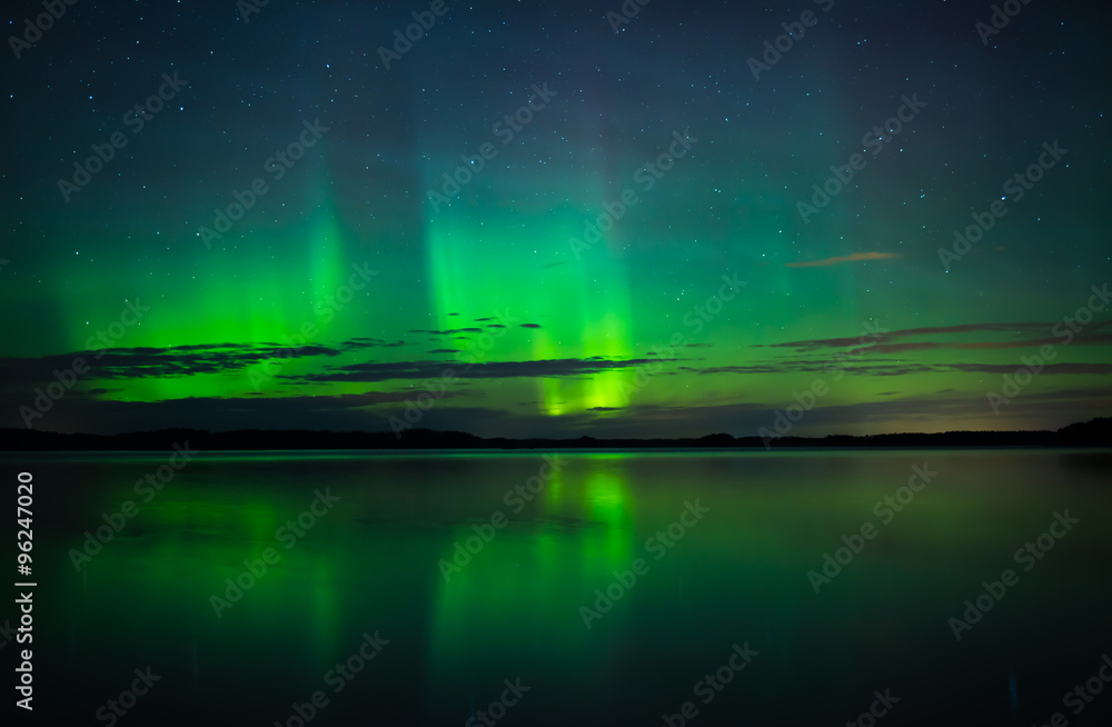 Northern lights over calm lake in Sweden (Aurora borealis)