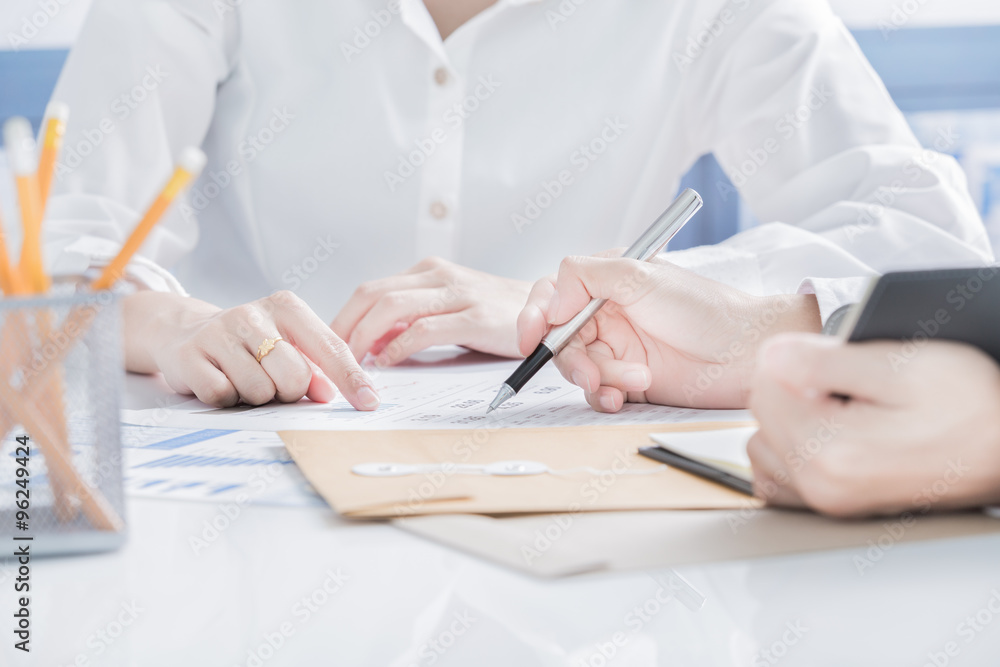 Business people discussing the charts and graphs showing the res Business people discussing the charts and graphs showing the res