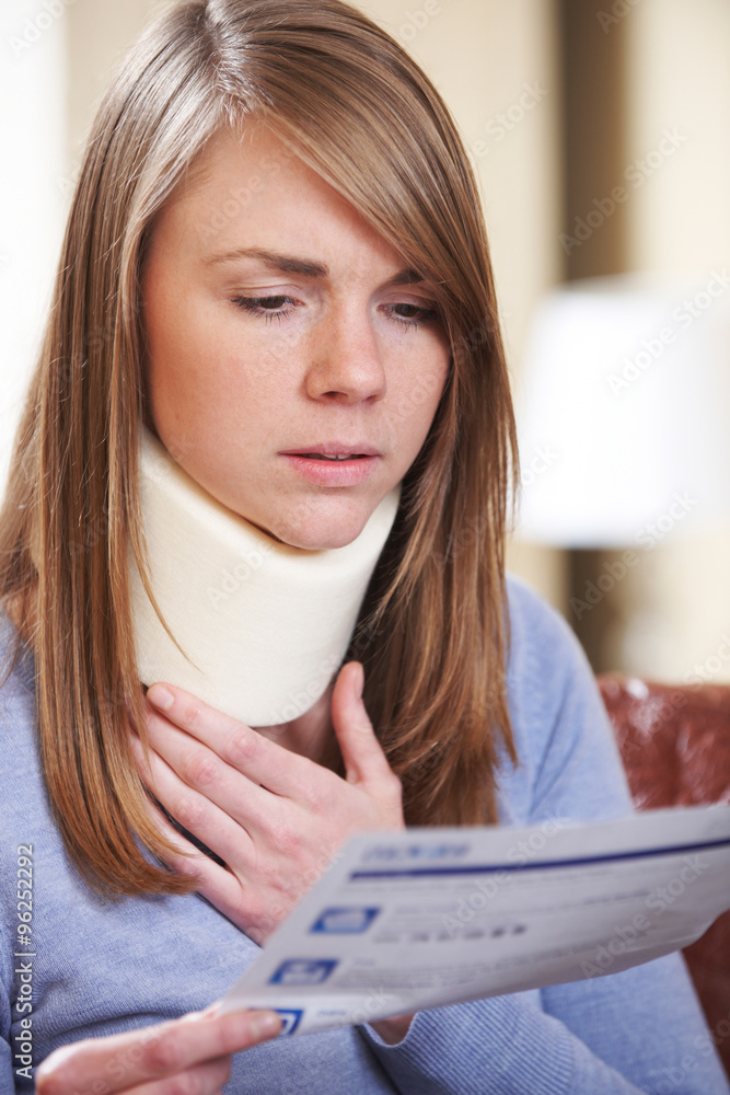 Young Woman Wearing Neck Brace Reading Letter