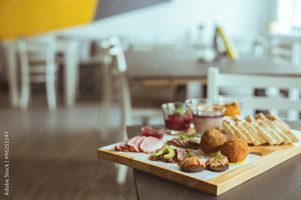 Vertical view of different snacks on chopping board