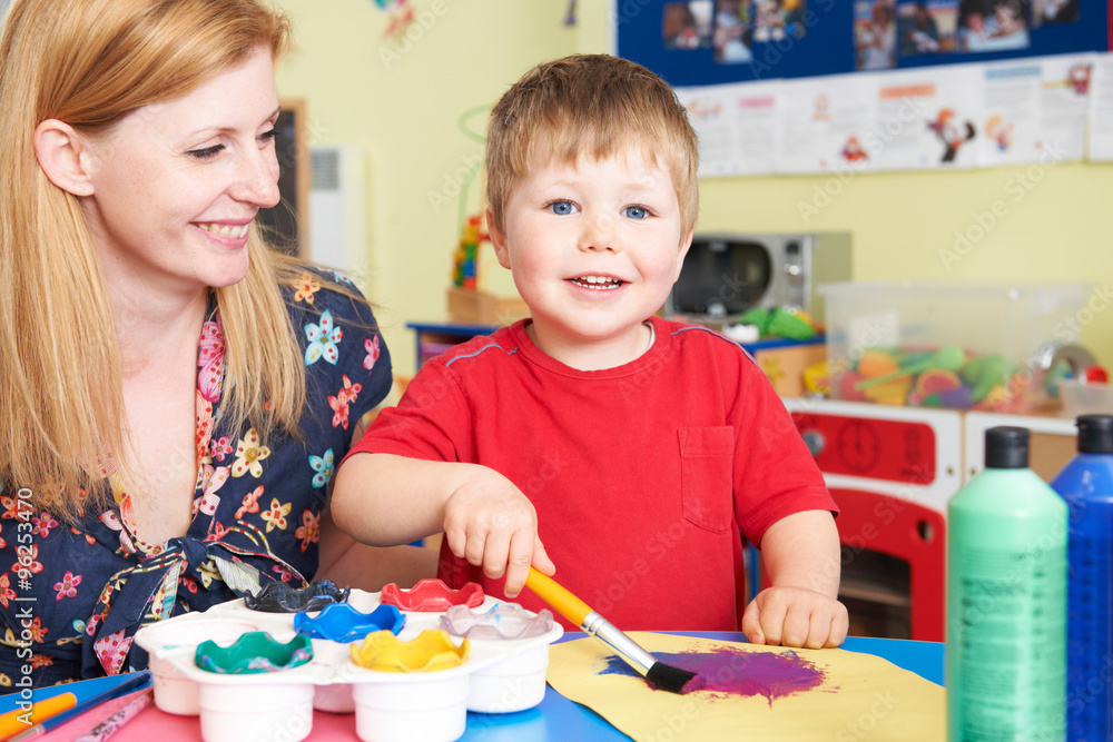 Teacher Helping Pre School Pupil In Art Class Teacher Helping Pre School Pupil In Art Class