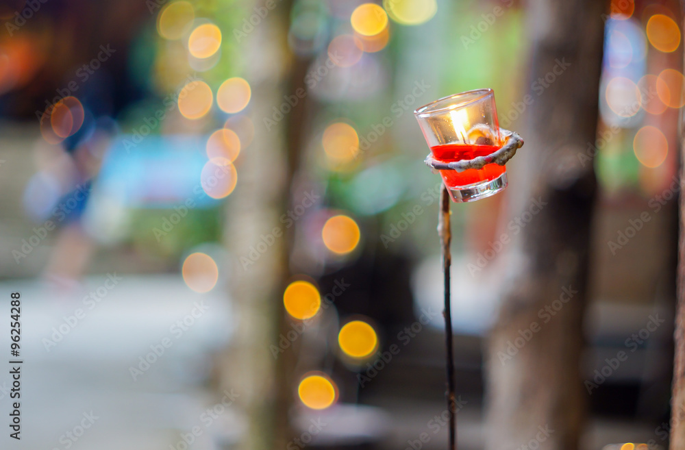 candle liquid in small glass isolated with bokeh background