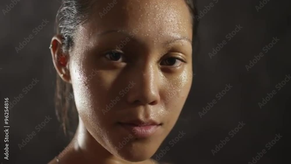 Fitness athlete woman sweating looking at camera Fitness athlete woman sweating looking at camera