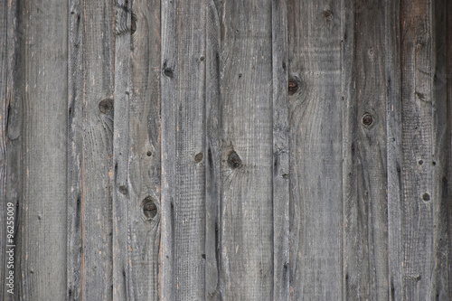 Vintage wooden fence with vertical planks and gaps