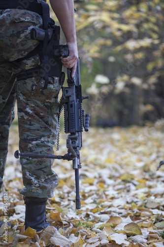 modern warrior with an automatic rifle in his hand