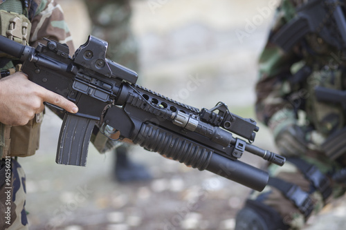 modern warrior with an automatic rifle in his hand