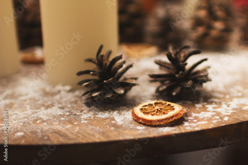 Christmas decorations. candles cones and orange with snowflakes 