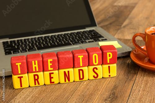 The Tops Trends written on a wooden cube in a office desk