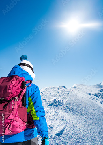 Woman on snowy mountain ridge