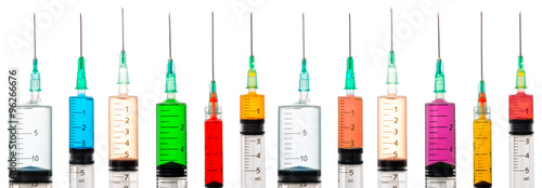 Various syringes filled with colored liquids photo