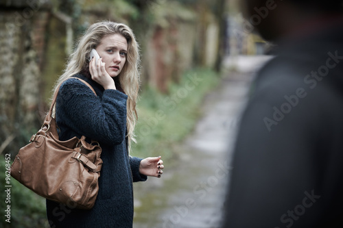 Teenage Girl Feeling Threatened As She Walks Along Path photo