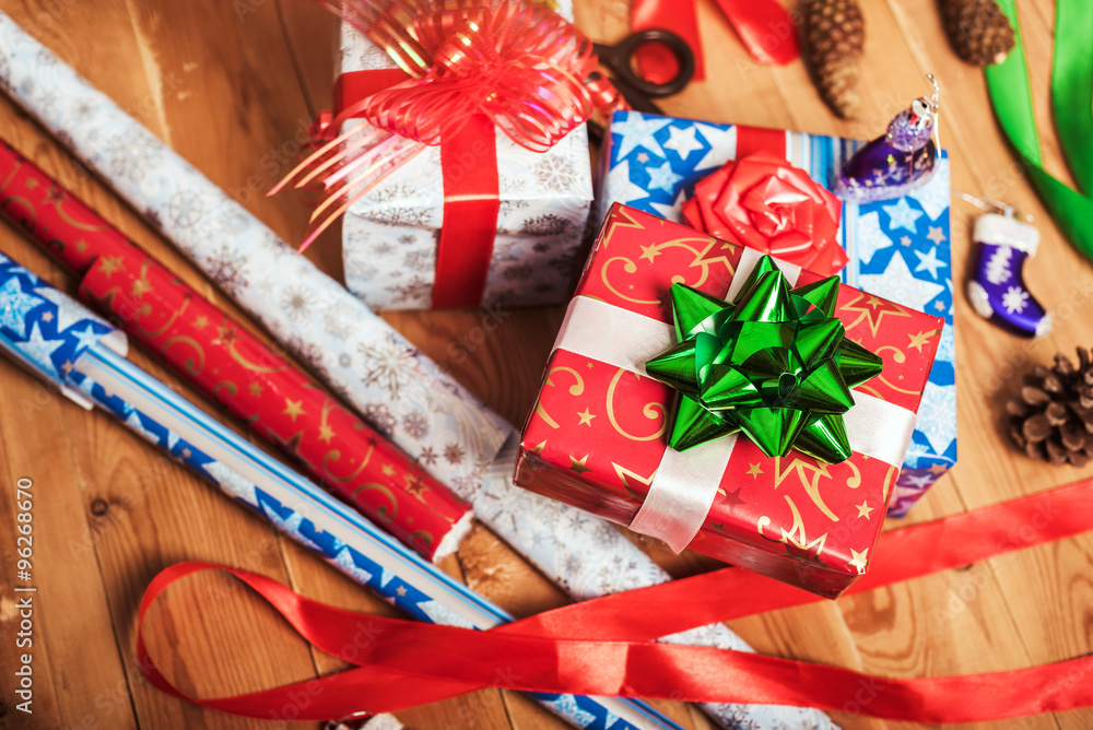 Objects for wrapping Christmas presents on wooden background 