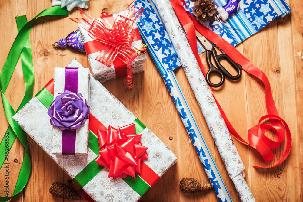 Fototapeta premium Objects for wrapping Christmas presents on wooden background 