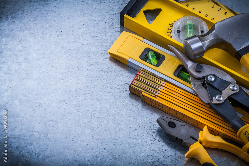 Composition of construction tools on scratched metallic backgrou