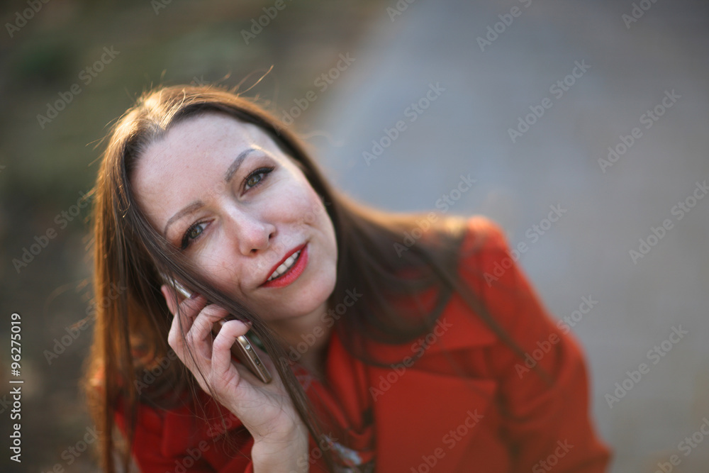 Fototapeta premium Successful beautiful business woman having phone conversation