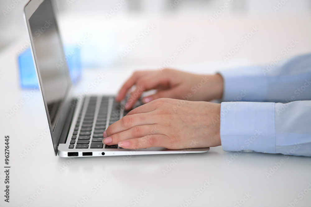 Young business woman working on laptop in office. Successful business concept. Young business woman working on laptop in office. Successful business concept.