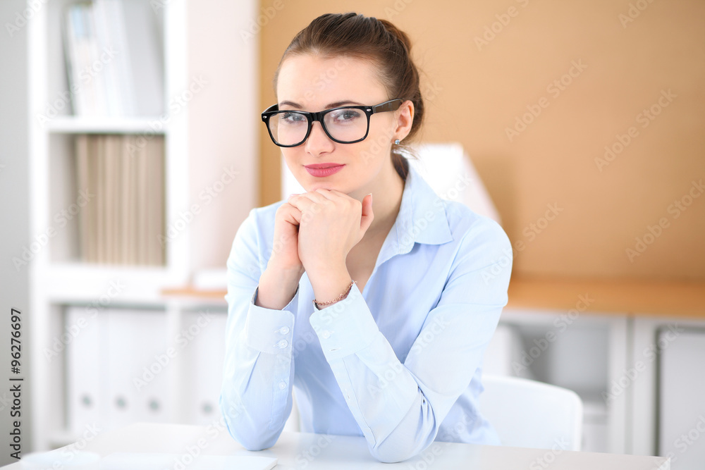 Young business woman working on laptop in office. Successful business concept. Young business woman working on laptop in office. Successful business concept.