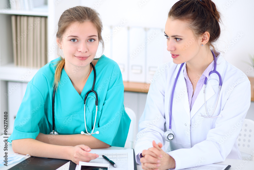 Female doctor and young surgeon intern in hospital Female doctor and young surgeon intern in hospital