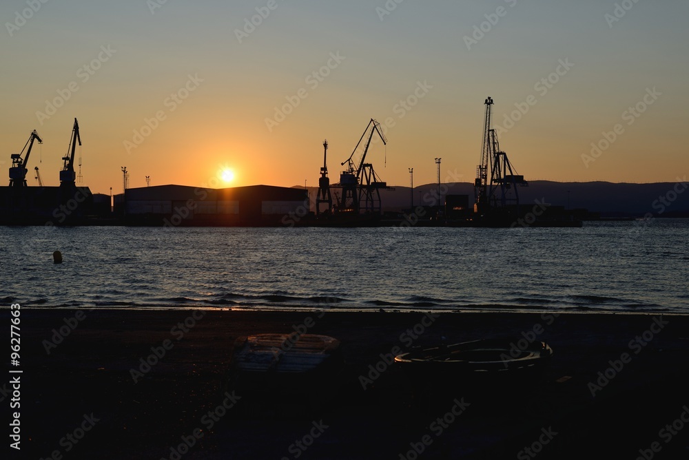 port cranes on a background of a sunset in the port