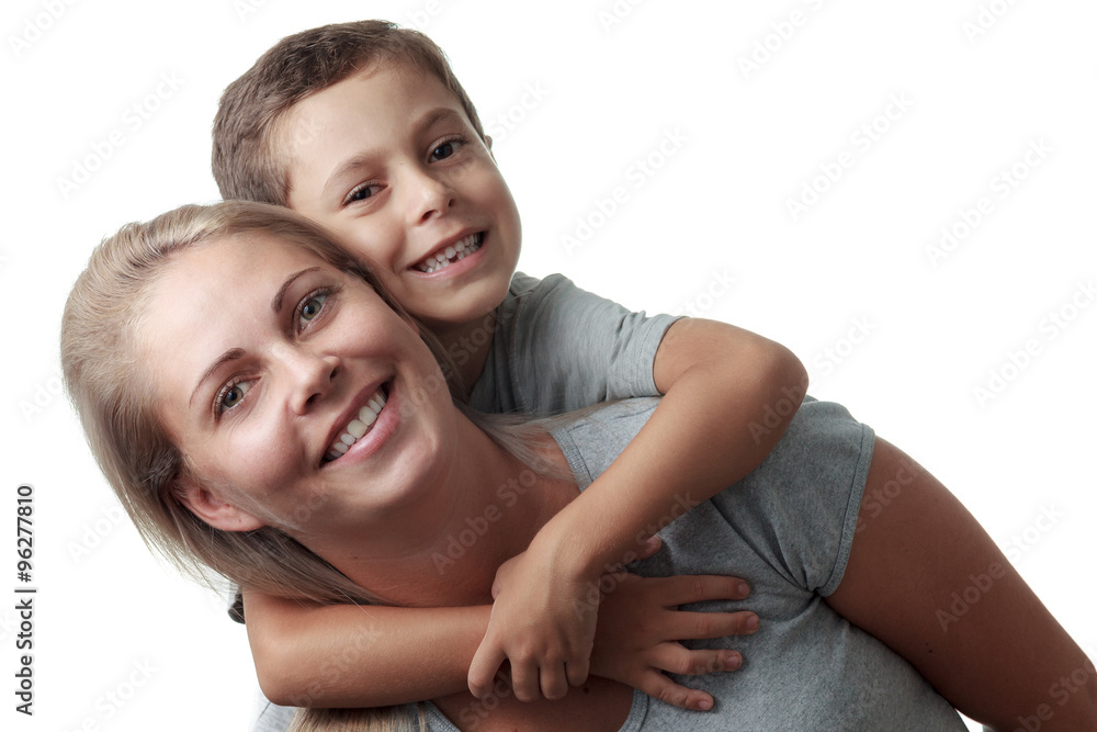 Fototapeta premium Son hugging his mother from behind and she smiling isolated on w