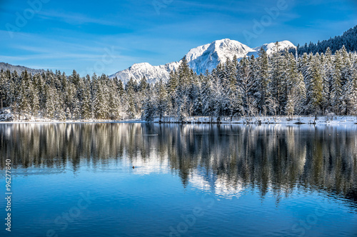 Scenic winter wonderland in Bavarian Alps at mountain lake Hintersee