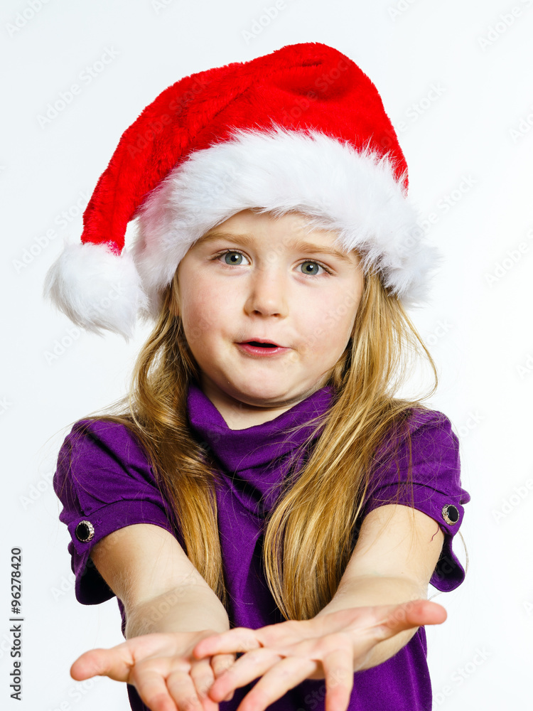 Cute little preschooler girl in red santa hat with gift box Cute little preschooler girl in red santa hat with gift box