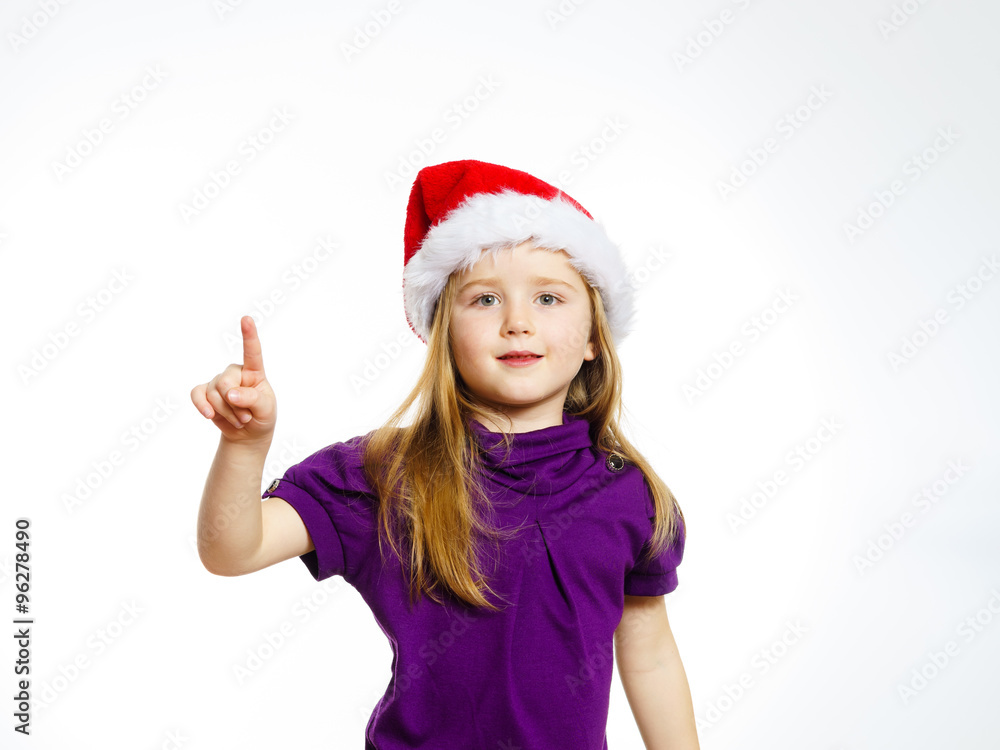 Cute little girl in santa hat touching transparent screen Cute little girl in santa hat touching transparent screen