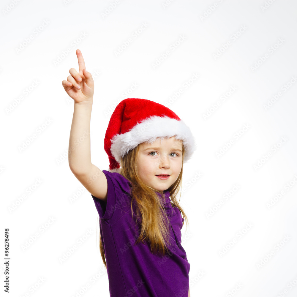 Cute little girl in santa hat touching transparent screen Cute little girl in santa hat touching transparent screen