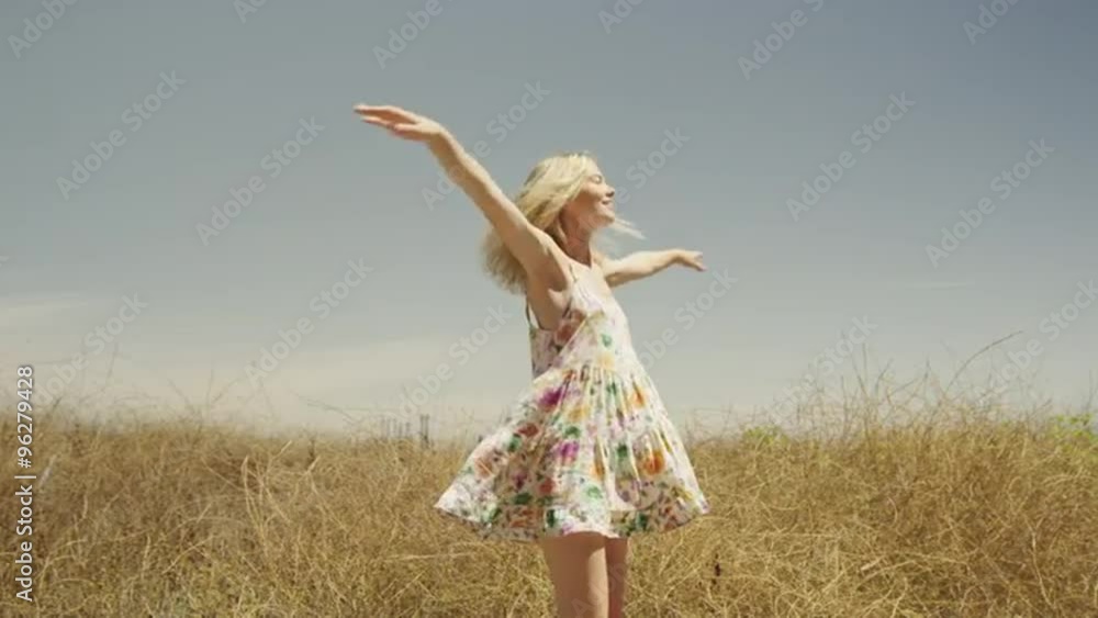 Pretty woman spinning around in tall grass Pretty woman spinning around in tall grass