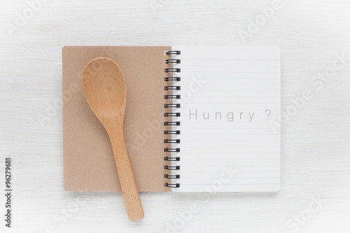 Empty notebook and kitchen utensils for food recipes.